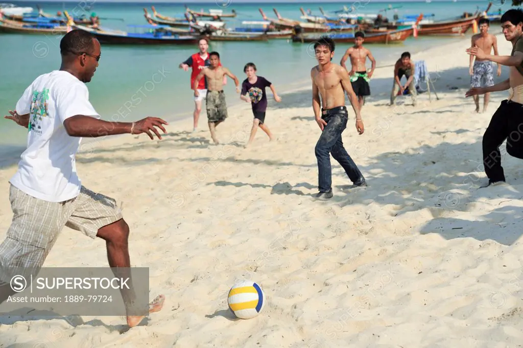 playing soccer on the beach, phi phi islands krabi thailand