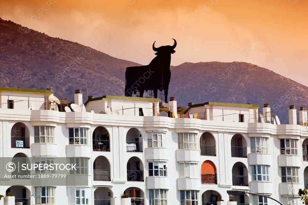 Silhouette Of The Black Osborne Bull Sitting On A Hill Behind Los Boliches, Fuengirola Malaga Province Costa Del Sol Spain
