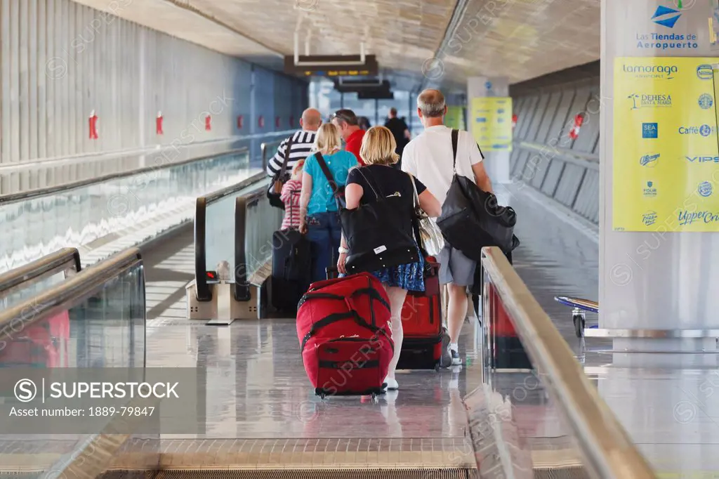 Tourists With Luggage Heading For The Departure Lounge At Malaga Airport, Malaga Province Costa Del Sol Spain