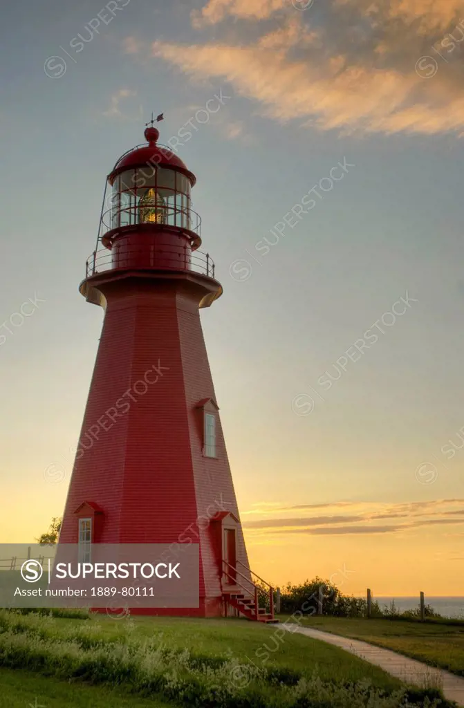 red lighthouse at sunset, la martre quebec canada