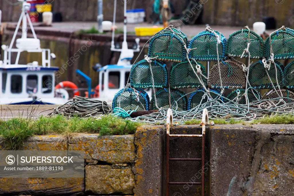 Crab traps piled on the shore at the harbour, burnmouth scottish borders scotland
