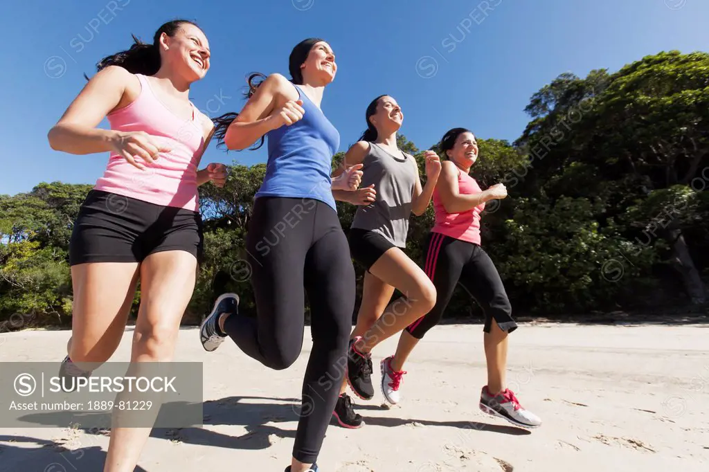 Four women running, gold coast queensland australia