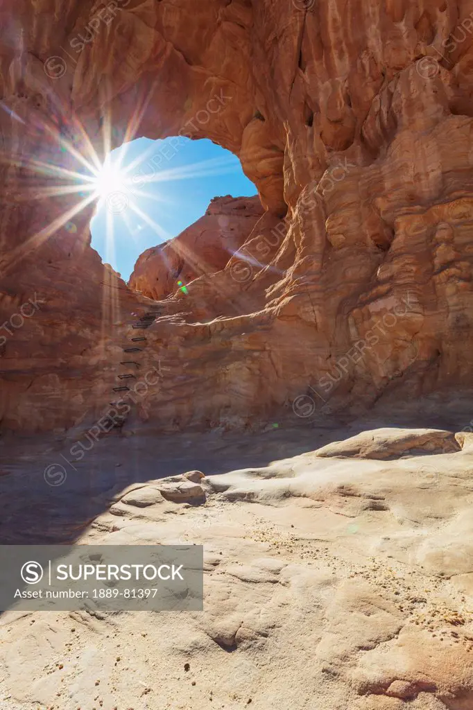 Sunlight shining through the hole in a rock formation, timna park arabah israel