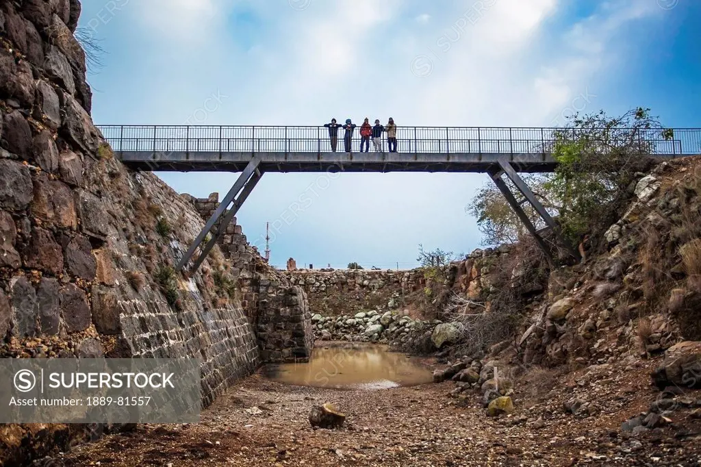 People standing on a bridge over a moat in kokhav ha yarden national park, israel