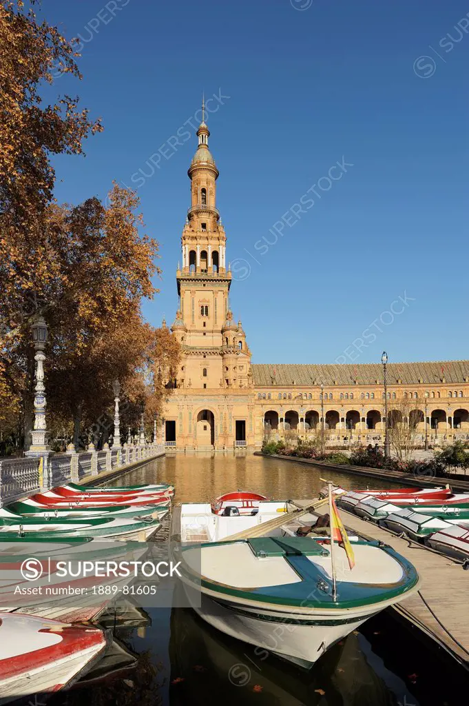 Boats in a canal at plaza de espana, seville andalusia spain