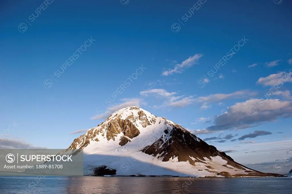 Snow covered mountain on the coast, antarctica