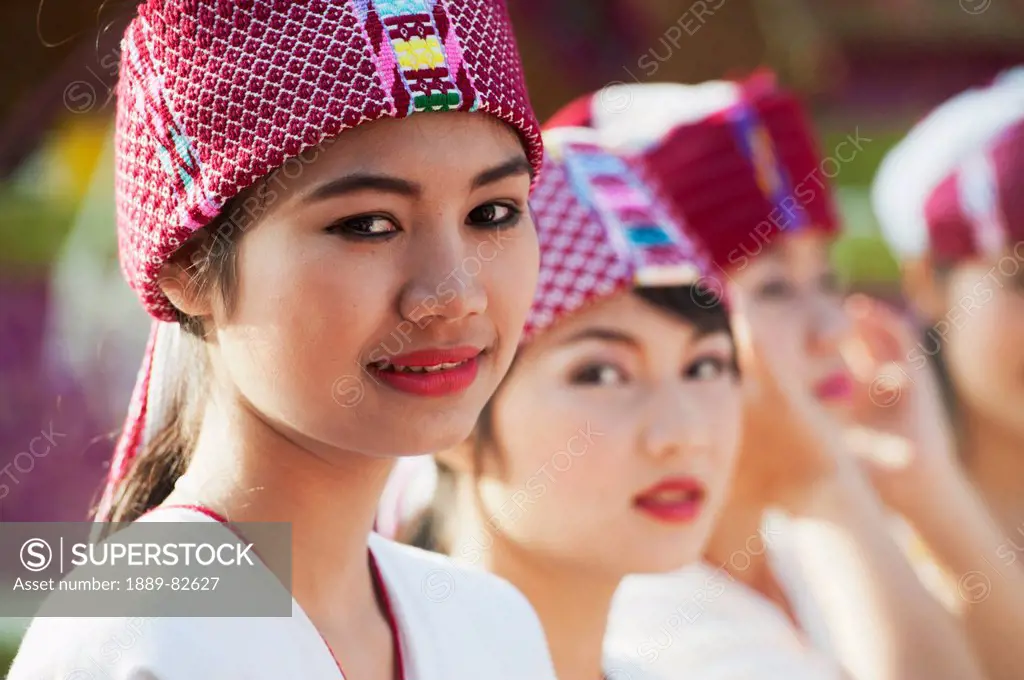 Young women dressed for the chiang mai flower festival parade, chiang mai, thailand