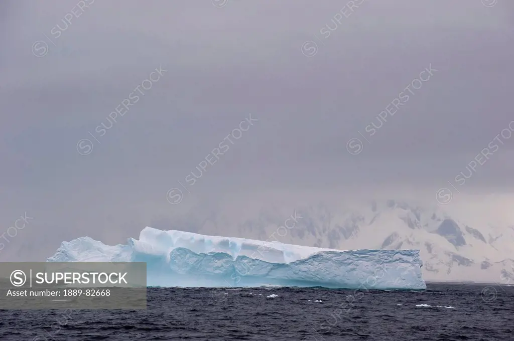 An iceberg in the water off the coast, antarctica