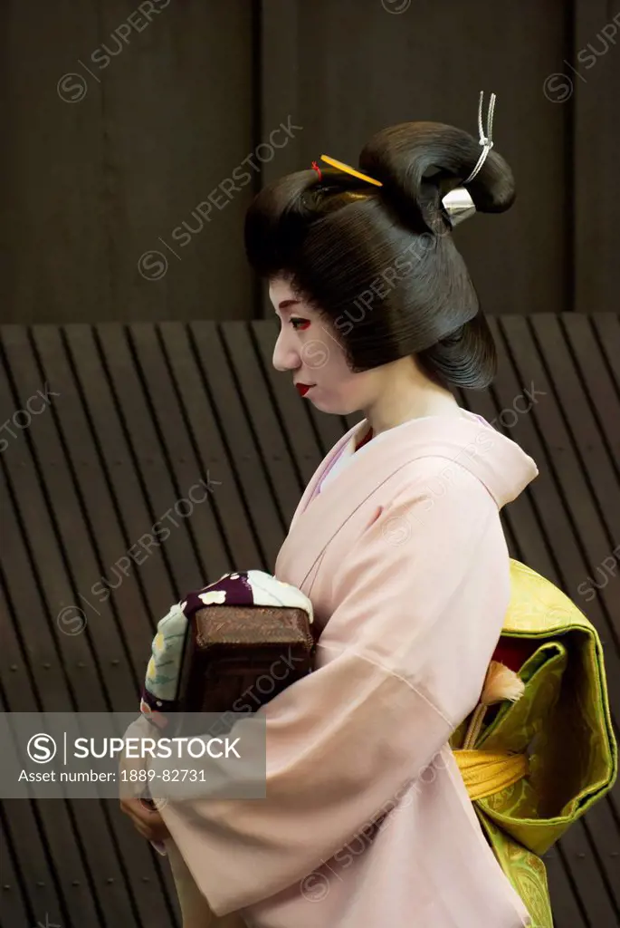 Geisha walking in a street, kyoto, japan