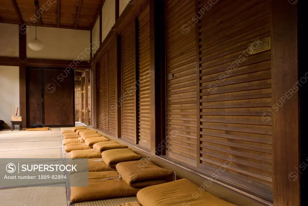 Row of zen meditation cushions in a japanese temple, kyoto, japan