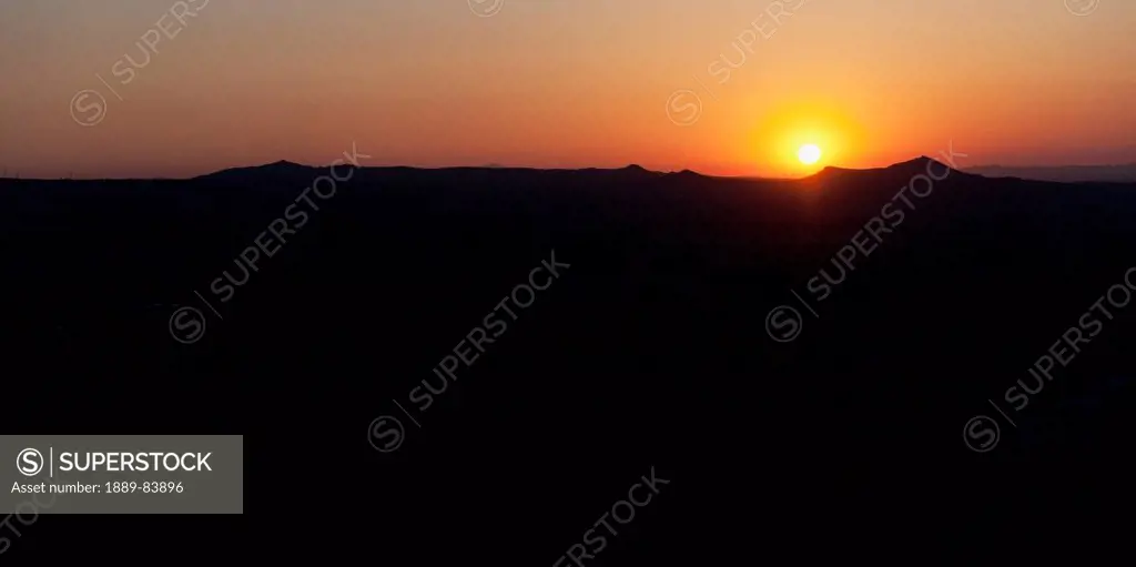 Silhouette Of The Landscape And An Orange Horizon With A Glowing Sun At Sunset, Aktepe Nevsehir Turkey