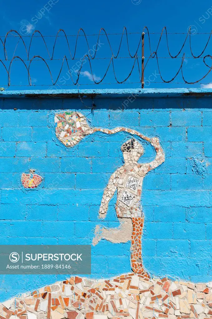 A Tile Mosaic Of A Human Figure Holding A Net And A Butterfly On A Blue Wall, Guatemala City Guatemala