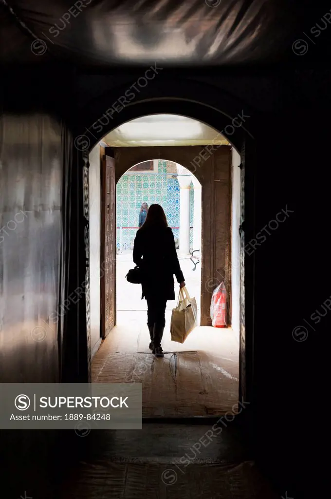 A Woman Walks Down A Hallway Carrying A Shopping Bag, Istanbul Turkey