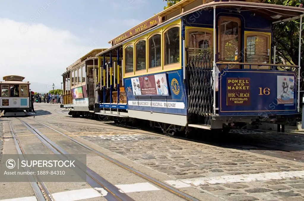 Colourful San Francisco Cable Cars On Cobbled Stone Street, San Francisco California United States Of America