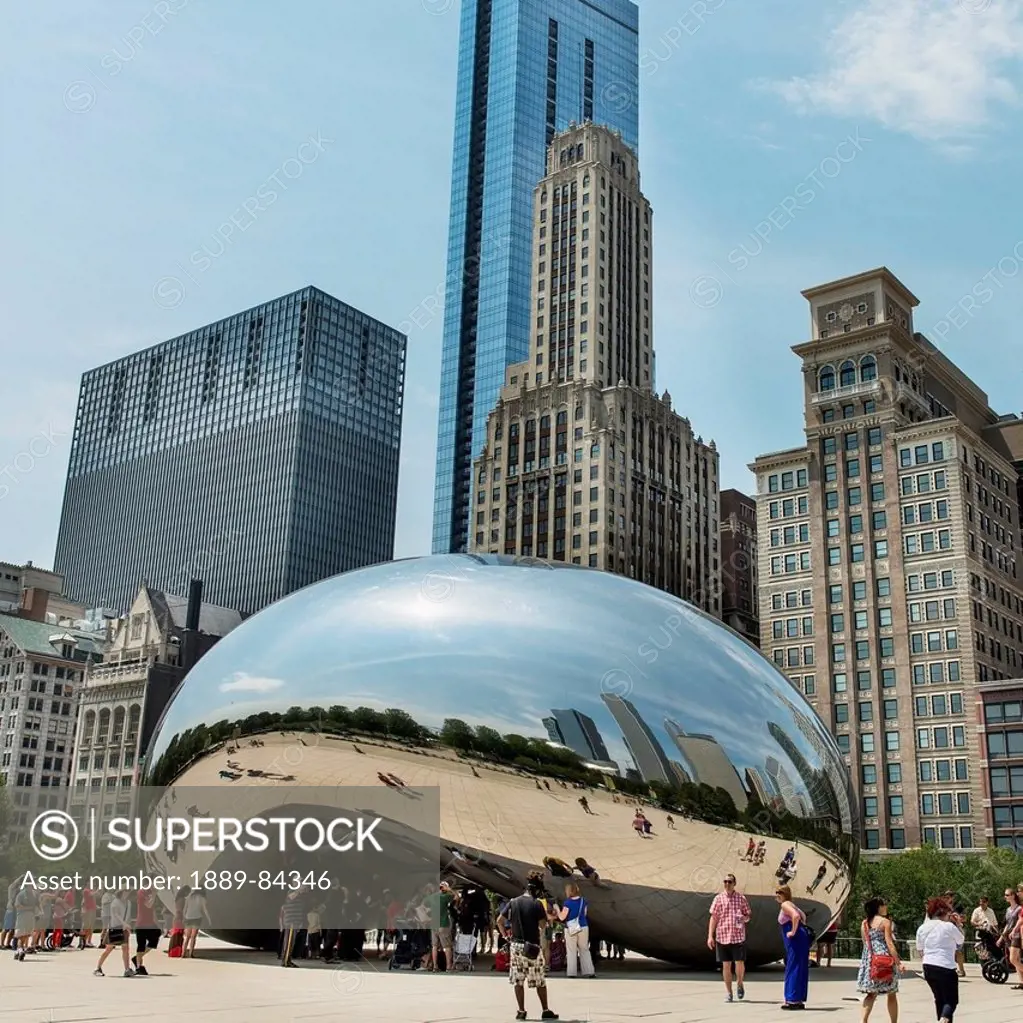 Pedestrians Standing By A Metallic Rounded Sculpture Reflecting The Skyscrapers Around It, Chicago Illinois United States Of America