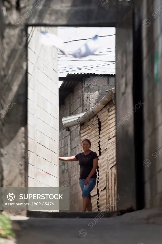 A Woman Standing At The Corner Of A Building, Guatemala City Guatemala