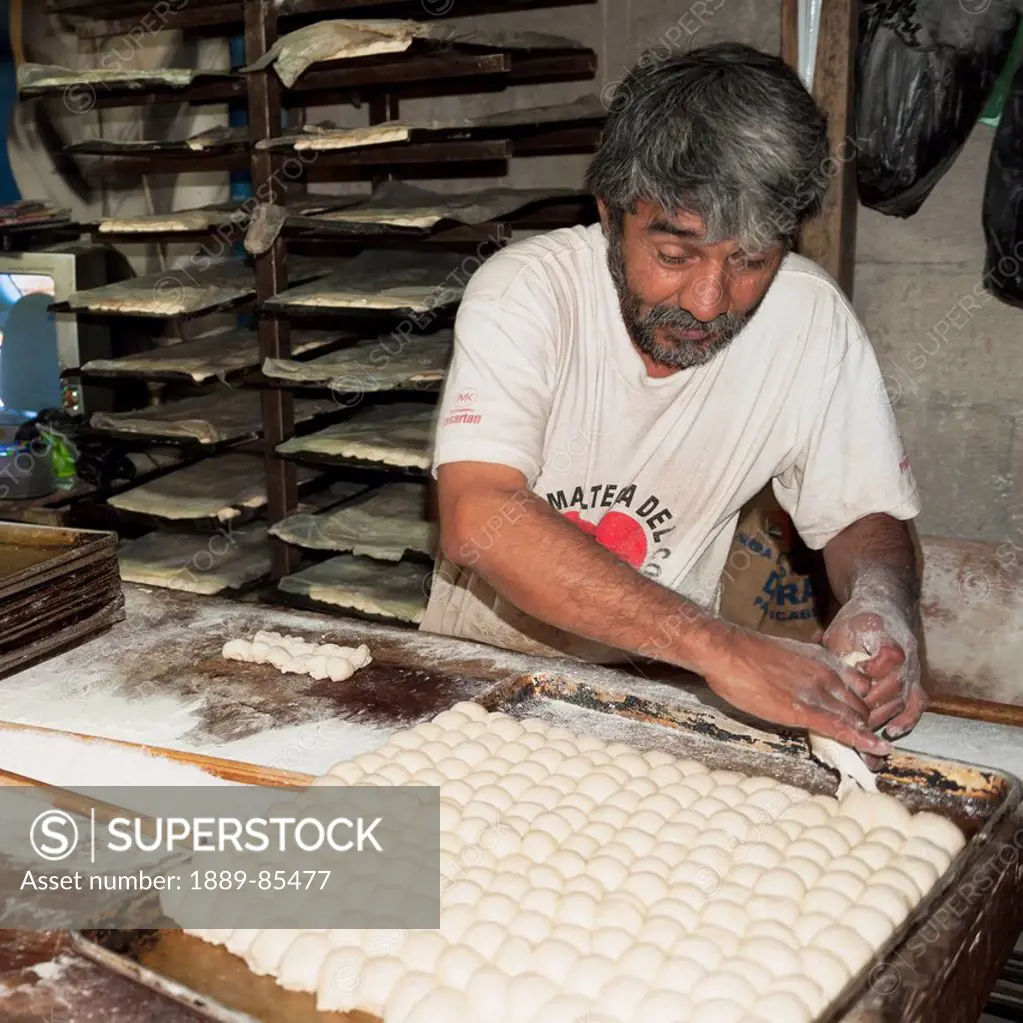 A Man Working With Dough In A Bakery, Guatemala City Guatemala