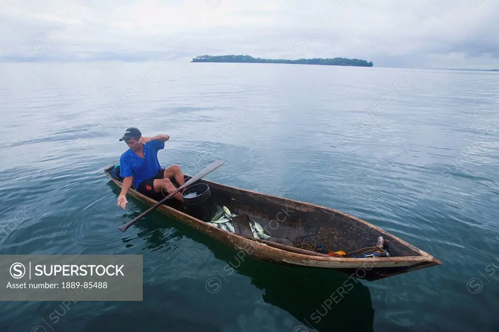 Man fishing in canoe type dugout boat, panama