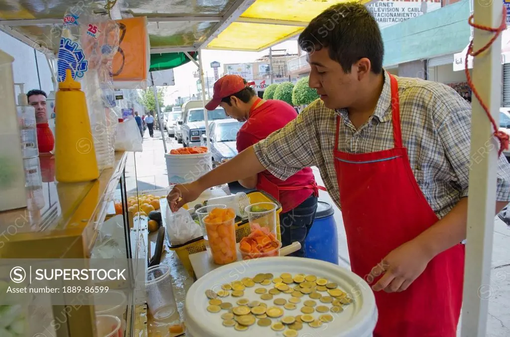 Mexico, Aguascalientes State, Street Side Vendor Preparing Fruit Cup; Aguascalientes