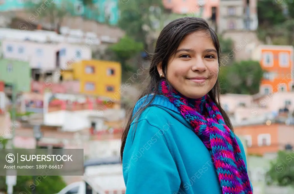 Mexico, Portrait Of Girl In Front Of Suburbs Houses; Guanajuato