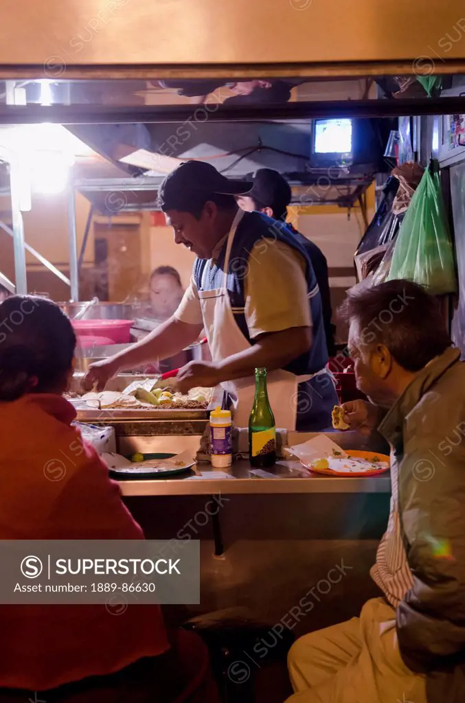 Mexico, Guanajuato, Customers Eating At Street Side Taco Stand; San Luis De La Paz