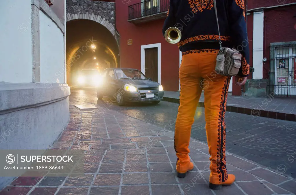 Mexico, Guanajuato, Trumpet Player Wearing Orange Mariachi Outfit; Guanajuato