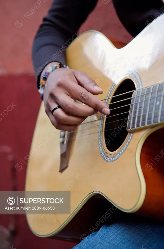 Mexico, Guanajuato, Female Musician Strumming Acoustic Guitar; Guanajuato