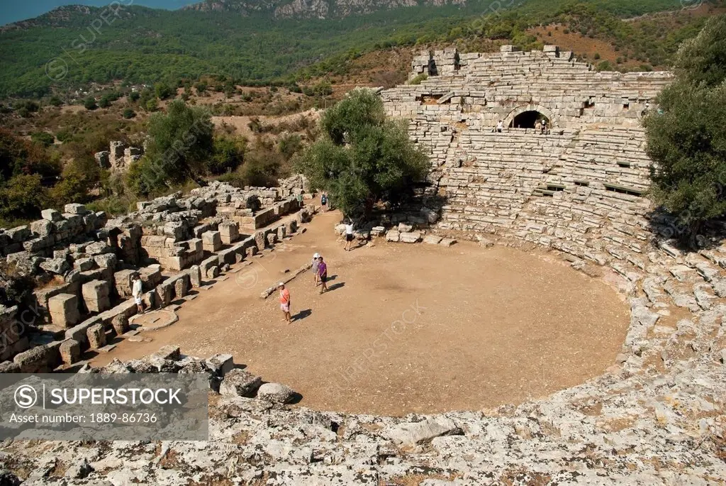Turkey, Well Preserved Theatre With Four People Standing On Stage; Kaunos