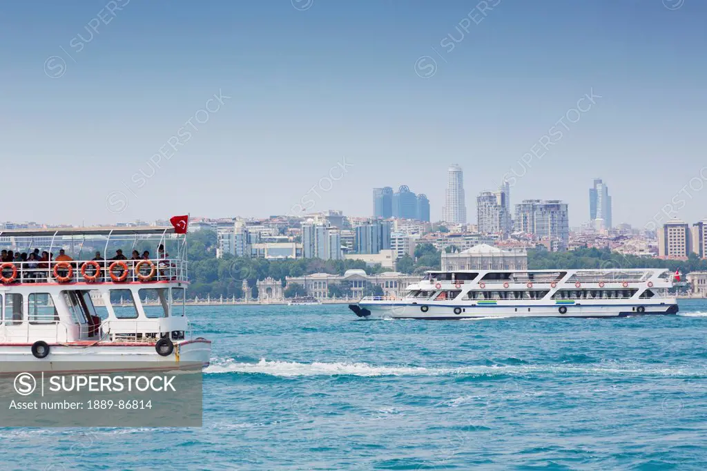Turkey, Istanbul, Modern Buildings On City Skyline Behind Dolmabahce Palace With Bosphorus Ferries In Foreground;;Turkey, Istanbul, Modern Buildings O...