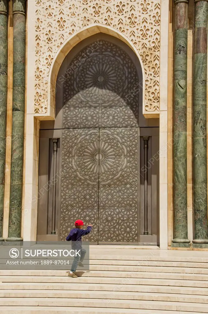 Morocco, Young Boy Jumping On Steps Of Hassan Ii Mosque; Casablanca