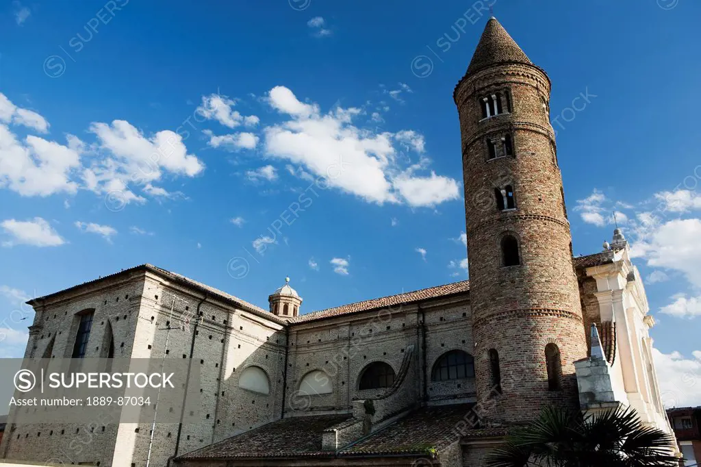 Italy, Emilia-Romagna, Brick Round Tower And Stone Church Against Sky With Clouds; Ravenna, Basilica Di San Vitale
