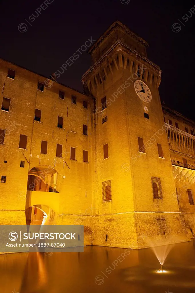 Italy, Emilia-Romagna, Illuminated Castello Estense Walls And Tower At Night; Ferrara