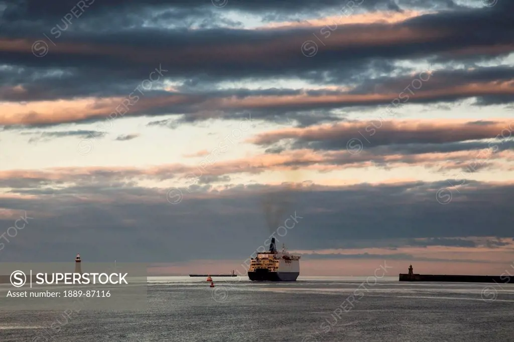 Uk, England, Tyne And Wear, Ship Pulling Into Port At Sunset; South Shields