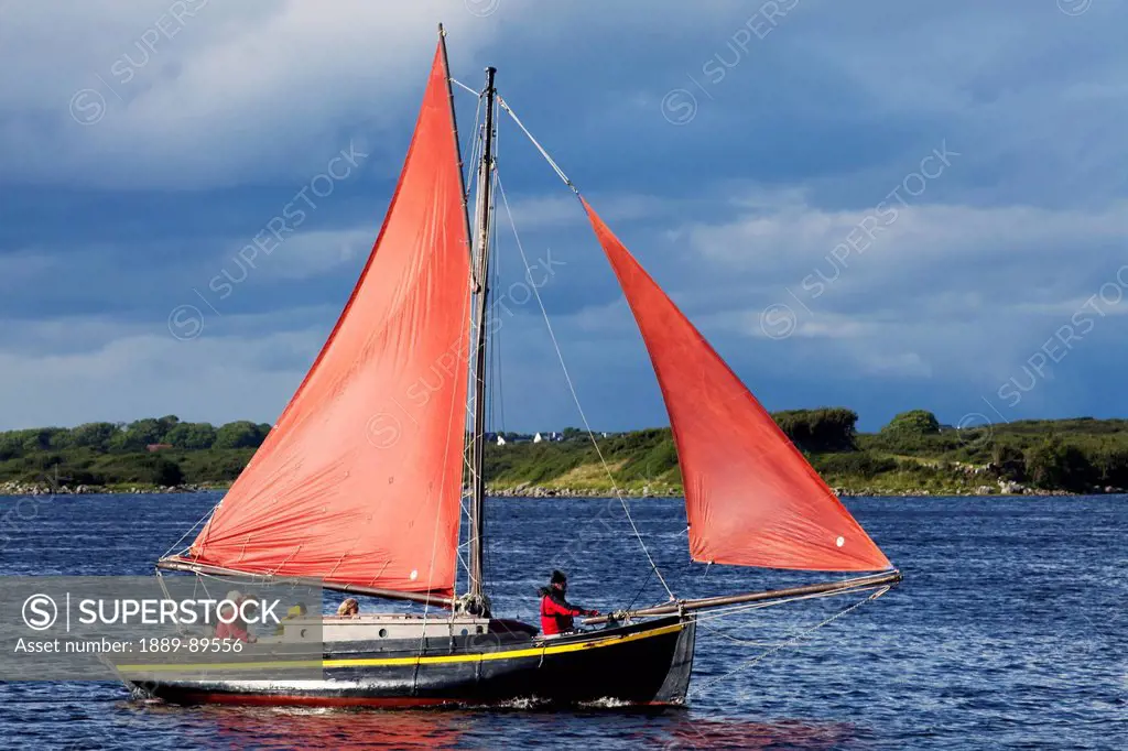 A boat with red sails in the galway hooker racing;Kinvara county galway ireland
