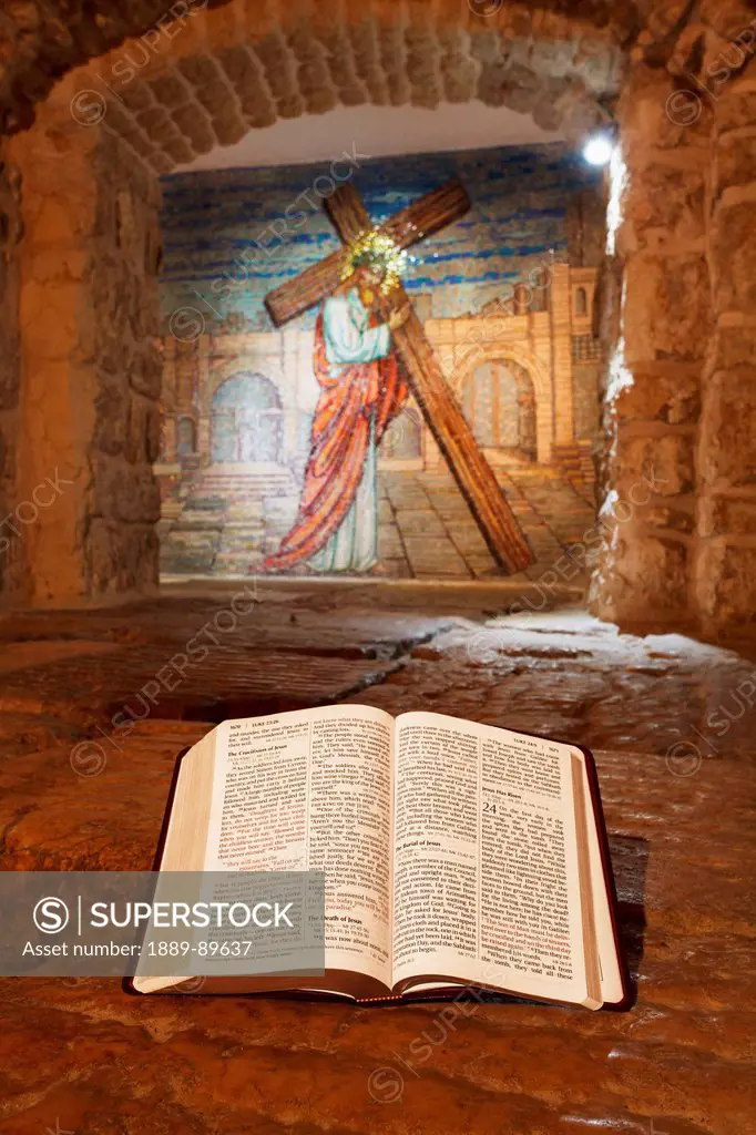 Close-up of Bible and mural with Jesus Christ; Jerusalem, Israel