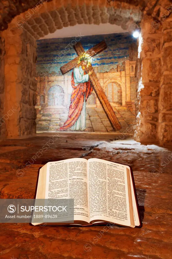 Close-up of Bible and mural with Jesus Christ; Jerusalem, Israel