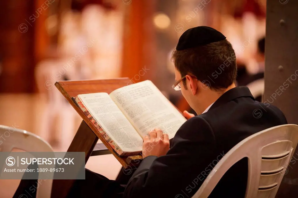 Orthodox Jew reading Torah; Jerusalem, Israel