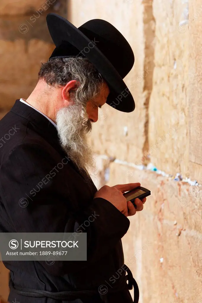 Side view of man praying at Wailing Wall; Jerusalem, Israel