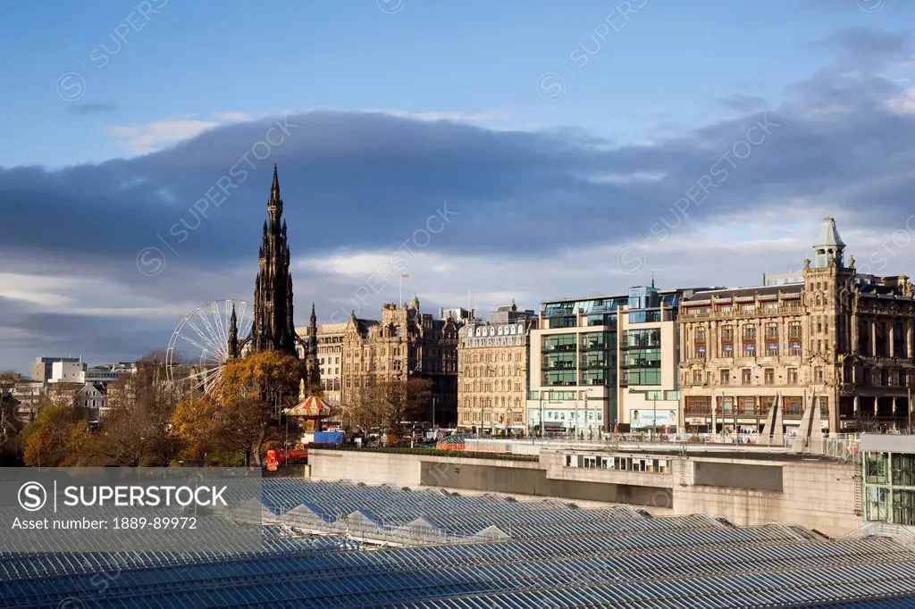 View of roofs and Princess Street Gardens with Scott Monument in background; Edinburgh, Scotland, United Kingdom