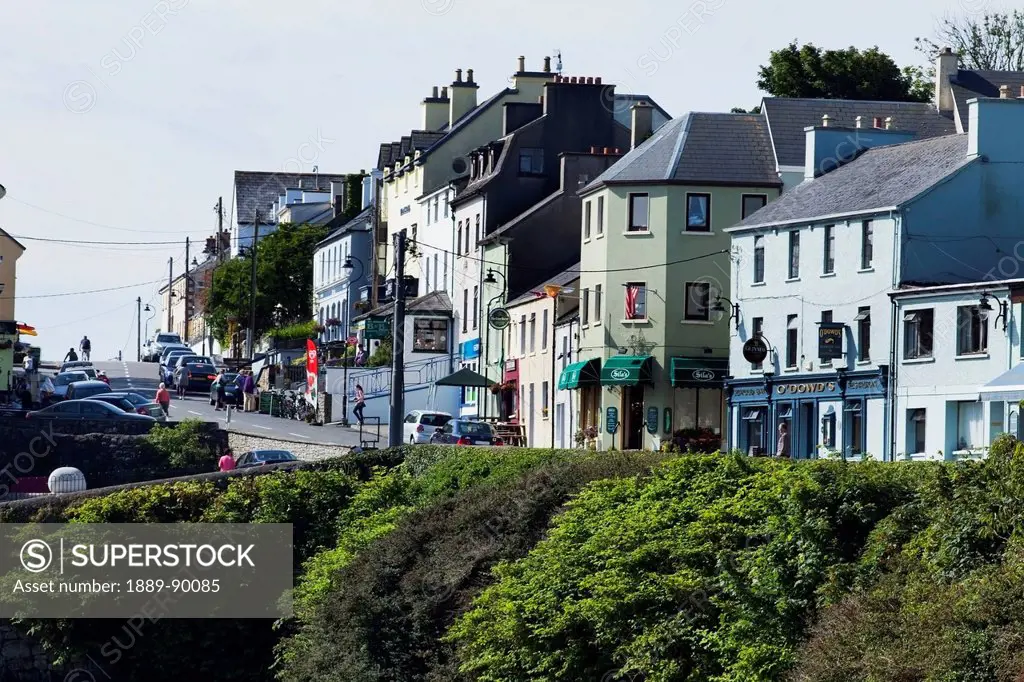 Colourful residential and retail buildings along a street;Roundstone county galway ireland
