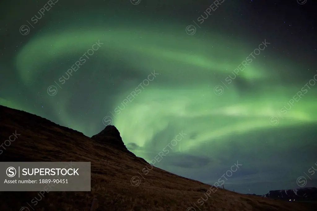 Northern lights (aurora borealis) over kirkjufell in the town of Grundarfjorthur, Snaefellsness Peninsula; Grundarfjorthur, Iceland