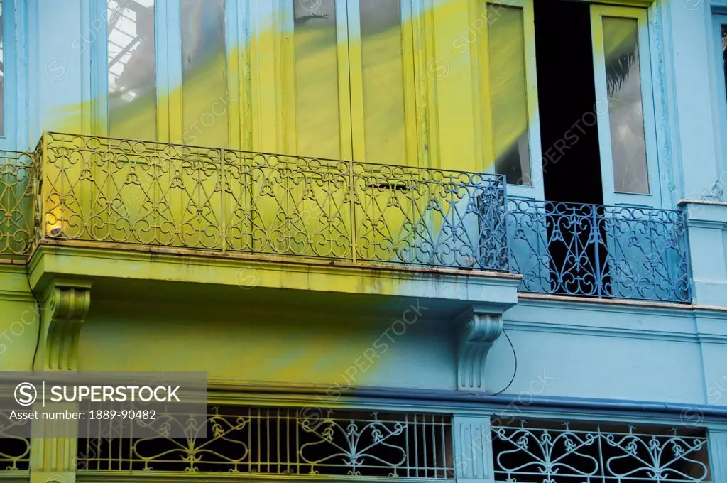 A blue building with a painted yellow streak across it in the Lapa neighbourhood; Rio de Janeiro, Brazil