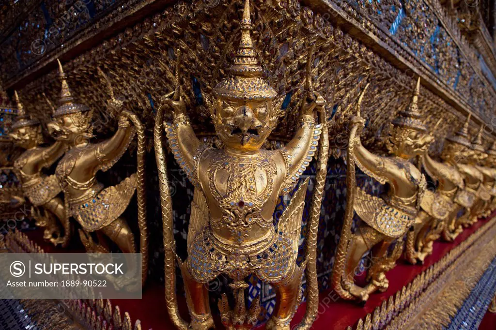 Golden garudas lined up around the main temple; Bangkok, Thailand