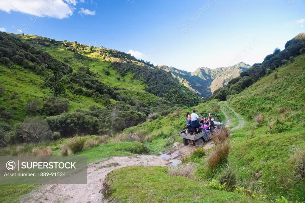 Travelers Explore The Grounds Of The Blue Duck Lodge On A Buggy Tour, Whanganui National Park; Whakahoro, New Zealand