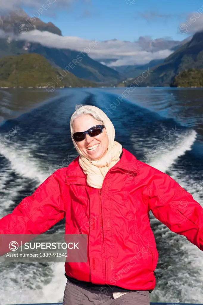 A Traveler Enjoys The Scenic Cruise Across Lake Manapouri To Doubtful Sound; New Zealand