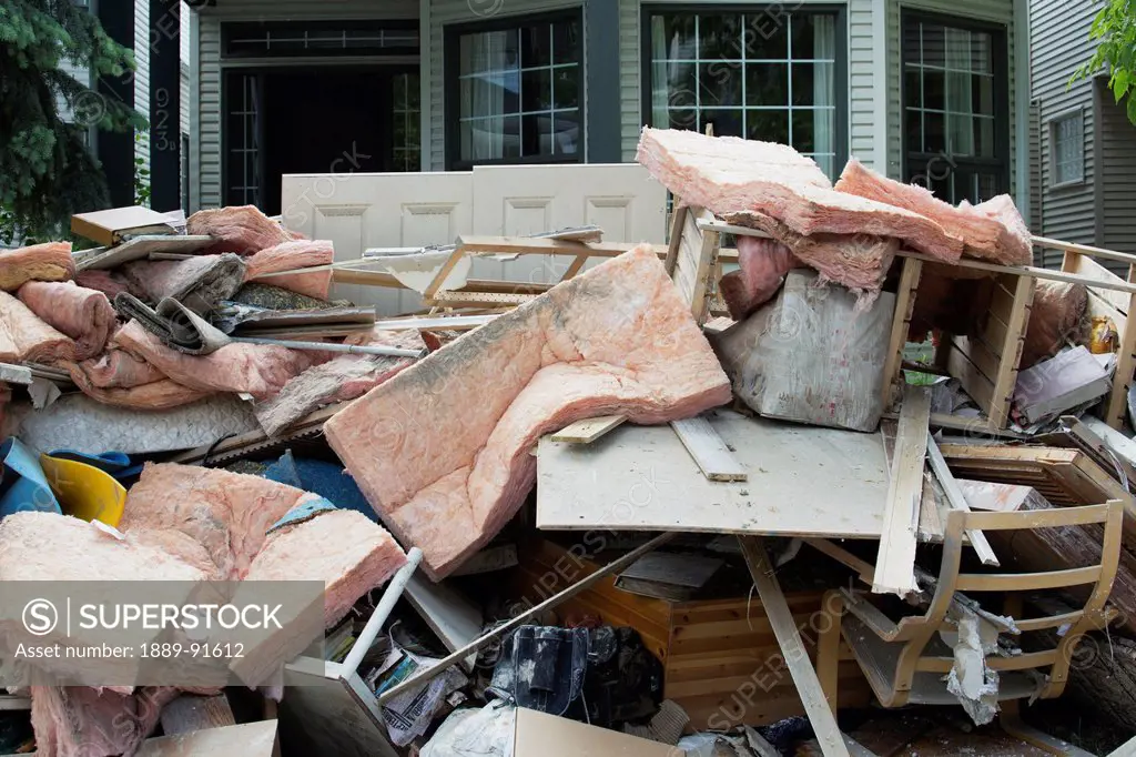 Garbage And Destroyed Household Items Piled Outside A Home After A Flood; Calgary, Alberta, Canada