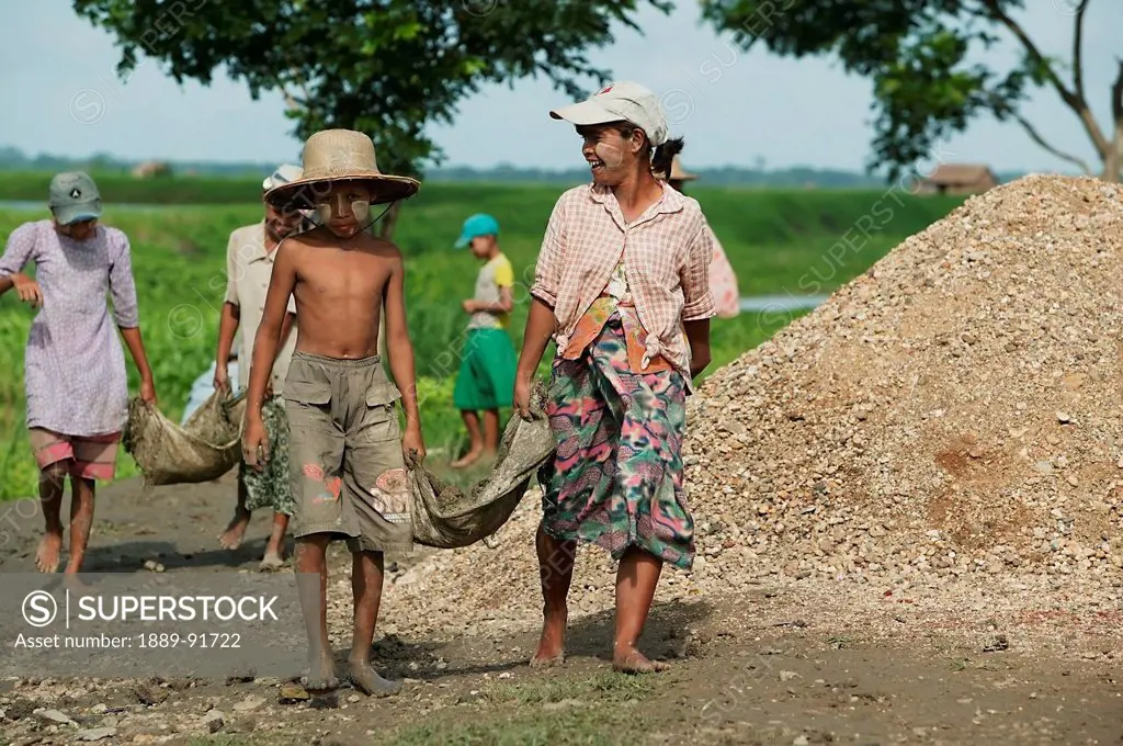 Children And Adults Work On Road Construction In Rural Myanmar; Ayeyarwady, Burma