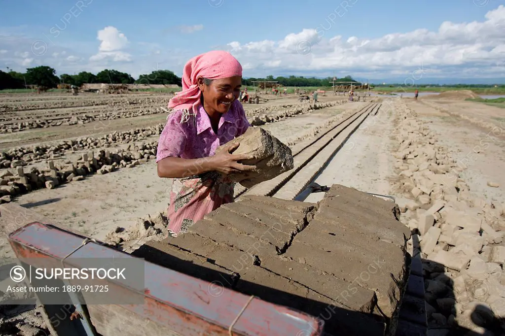 Woman Working To Make Bricks From Clay In Myanmar; Ayeyarwady, Burma