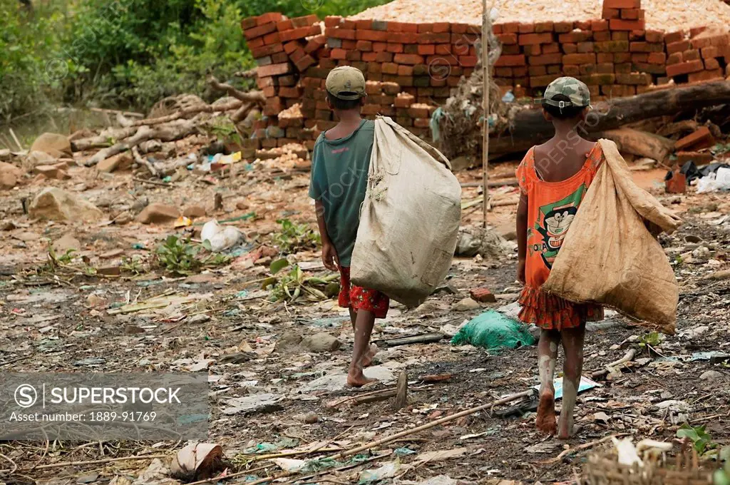 Two Small Boys Scavenge For Things To Recycle And Sell Along The Riverbank Mud, Labutta, Ayeyarwady River Delta, Myanmar; Ayeyarwady, Burma