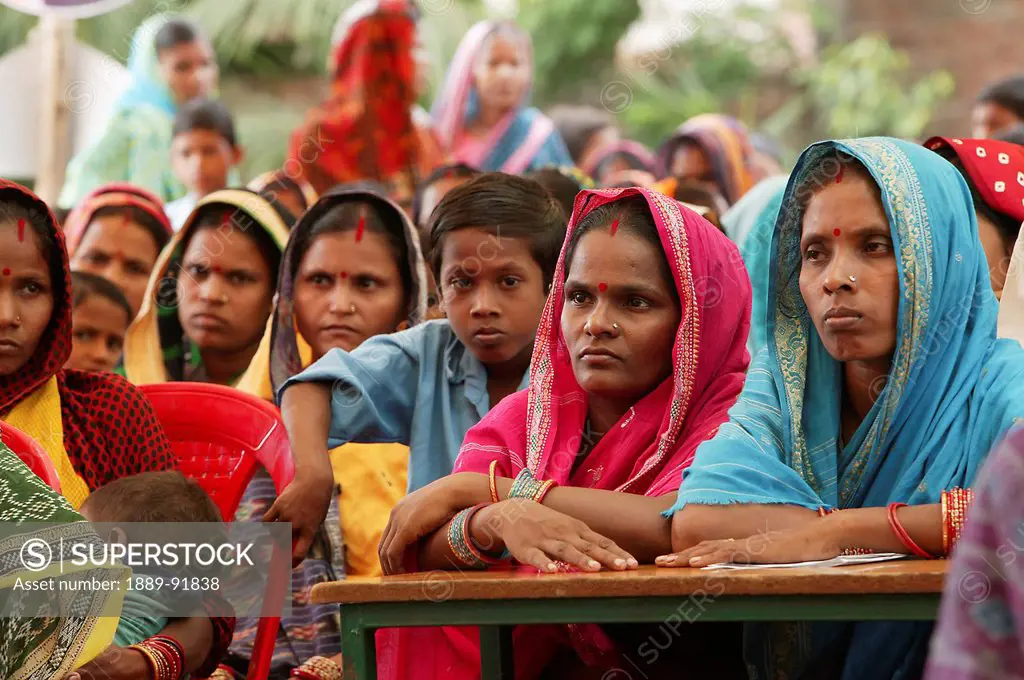 A group of women and children gather to hear about birth registration; India